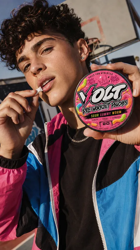 Athlete with VOLT Sour Gummy Worm pouches on an outdoor court